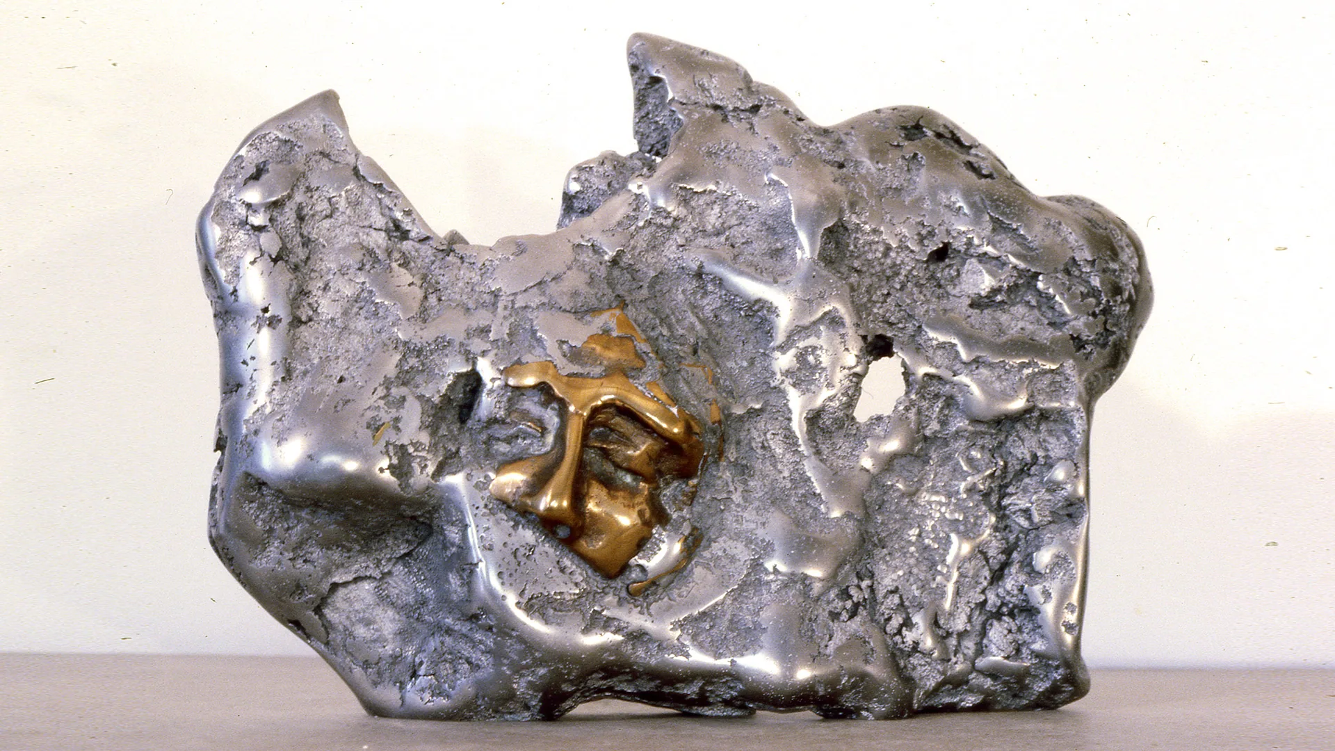 Volcanic Icon | aluminum & bronze | 14 x 20 x 5 inches Knot, Head, Sand-casted aluminum & bronze sculpture by Mel Hantz